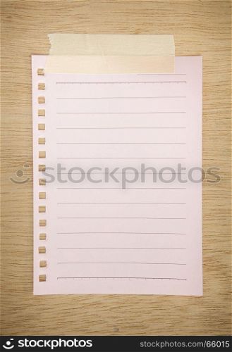 pink paper sheet on wood texture background
