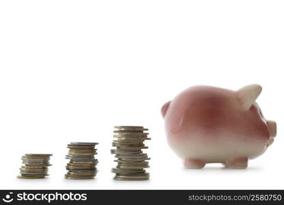 Pink piggy bank isolated on white background with coins