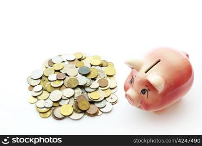 Pink piggy bank isolated on white background with coins