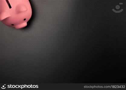 Pink Piggy Bank on a Black background top view with copy space.Savings,Financial and business concept space for text. Pink Piggy Bank on a Black background top view with copy space.Savings,Financial and business concept