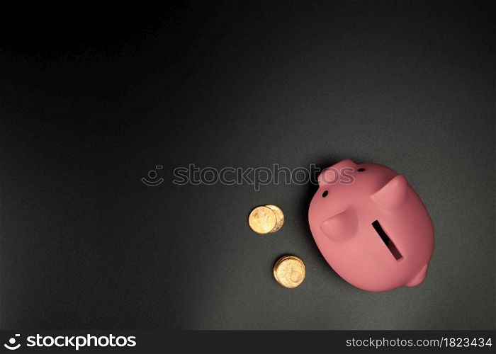 Pink Piggy Bank on a Black background top view with copy space.Savings,Financial and business concept space for text. Pink Piggy Bank on a Black background top view with copy space.Savings,Financial and business concept