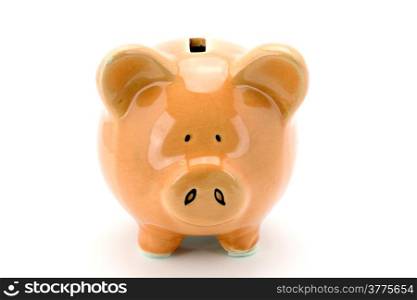 Pink piggy bank standing on a white background.