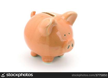 Pink piggy bank standing on a white background.