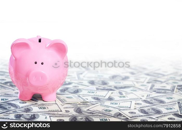 Pink Piggy Bank Standing on the Field of Dollars Notes