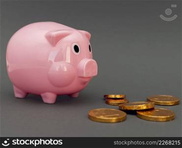 pink piggy bank with golden coins