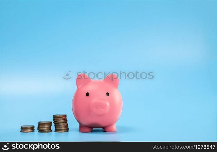 Pink Piggy Bank with stack of coins, growth and saving concept, Business and financial with copy space. space for text. Pink Piggy Bank with stack of coins, growth and saving concept, Business and financial with copy space.