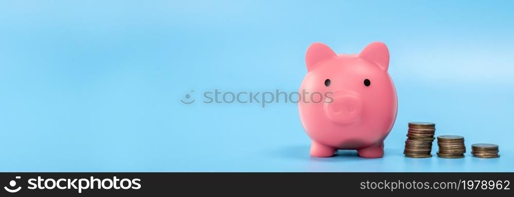 Pink Piggy Bank with stack of coins, growth and saving concept, Business and financial with copy space. web banner with space for text. Pink Piggy Bank with stack of coins, growth and saving concept, Business and financial with copy space. Web banner