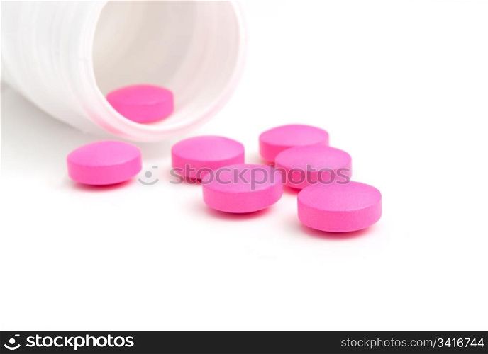 Pink Pills in White Bottle On White Background