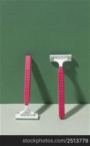 pink razor blades leaning wall