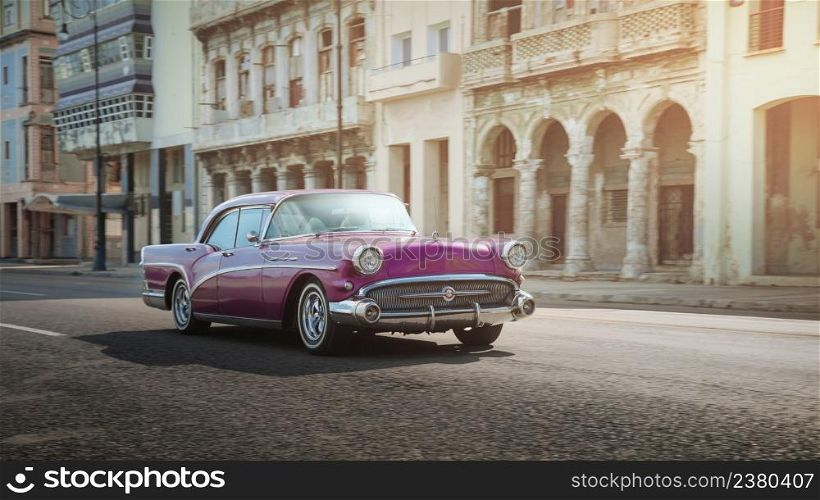 Pink retro car on the street of Havana, Cuba, shot with panning