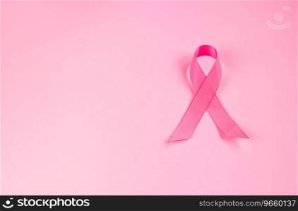 Pink ribbon on colored background. Breast Cancer Awareness Month symbol. Women’s health care concept. Promotion of c&aign to fight cancer. Copy space.. Pink ribbon on colored background. Breast Cancer Awareness Month symbol. Women’s health care concept. Promotion of c&aign to fight cancer. 