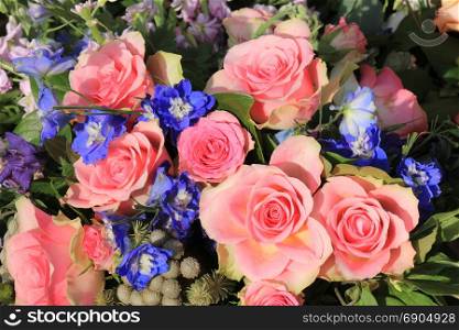 Pink roses and blue larkspur in a floral wedding decoration