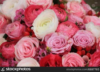 Pink roses and buttercups in a mixed pink bridal bouquet