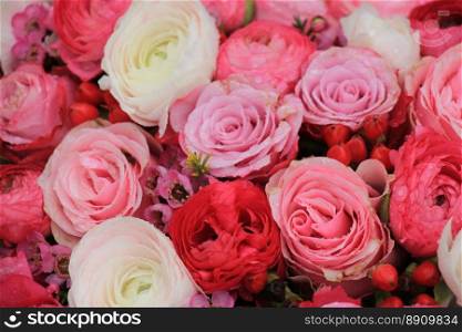 Pink roses and buttercups in a mixed pink bridal bouquet