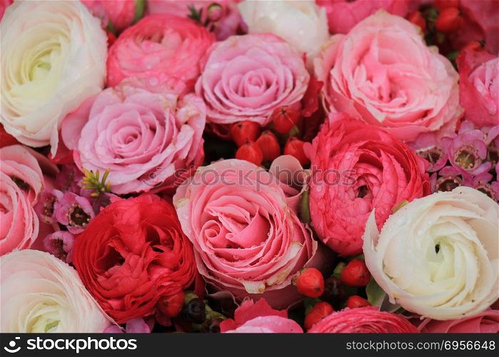 Pink roses and buttercups in a mixed pink bridal bouquet. Mixed pink bridal bouquet