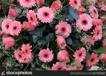 pink roses and gerberas and gypsophila in a mixed floral arrangement