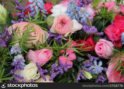 pink roses and ranonkels, blue common hyacints in a spring flower wedding centerpiece
