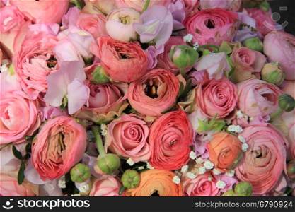 Pink roses and ranunculus in a bridal bouquet