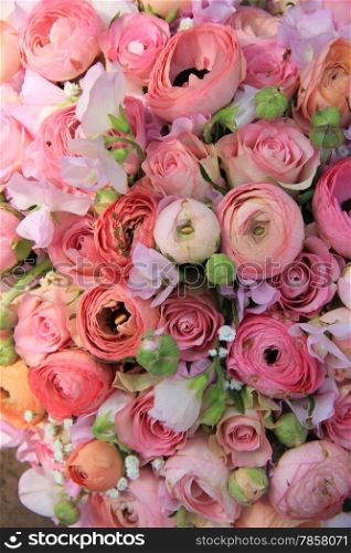 Pink roses and ranunculus in a bridal bouquet
