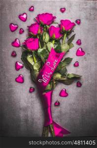 Pink roses bouquet with loop, hearts and handwritten lettering with love, top view. Love symbol an Valentines day concept