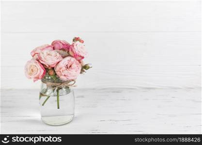 pink roses flower glass jar white wooden textured backdrop . Resolution and high quality beautiful photo. pink roses flower glass jar white wooden textured backdrop . High quality and resolution beautiful photo concept