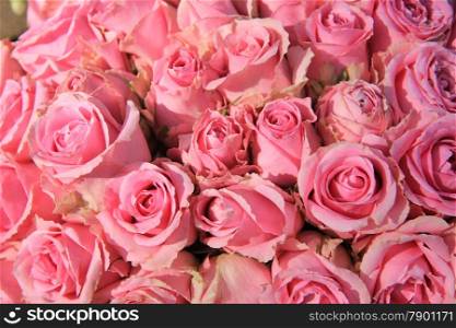 Pink roses in a big bridal bouquet and centerpieces