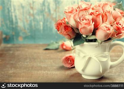 Pink roses in a pot on blue background