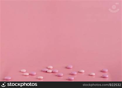 Pink round pills with a top spot for a text banner. Concept for pharmacy advertising. Pink round pills with a top spot for a text banner