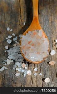 Pink salt from the Himalayas on wooden background