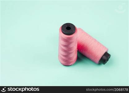 pink spools mint background