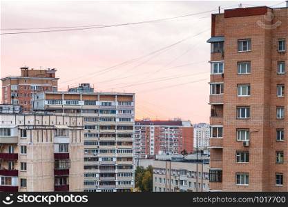 pink sunset sky over residential quarter in Moscow city in autumn evening