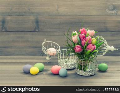 pink tulip flowers and easter eggs. vintage style toned picture