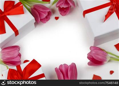 Pink tulip flowers gifts and red hearts composition on white background top view with copy space. Valentine&rsquo;s day, birthday, wedding, Mother&rsquo;s day concept. Copy space. Pink tulips hearts card