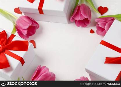 Pink tulip flowers gifts red hearts and gifts composition isolated on white background top view with copy space. Valentine&rsquo;s day, birthday, wedding, Mother&rsquo;s day concept. Copy space. Pink tulips hearts gifts card