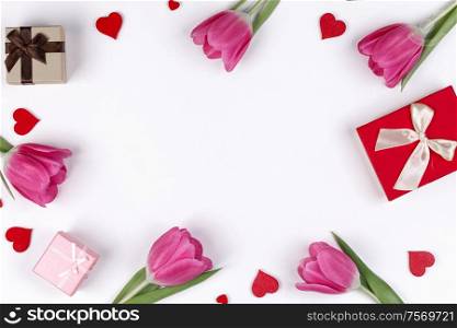 Pink tulip flowers gifts red hearts and gifts composition isolated on white background top view with copy space. Valentine&rsquo;s day, birthday, wedding, Mother&rsquo;s day concept. Copy space. Pink tulips hearts gifts card