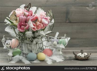 pink tulips, feathers, butterflies and colored easter eggs