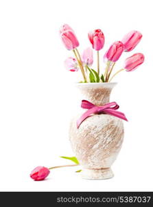 Pink tulips in vase with bow isolated on white