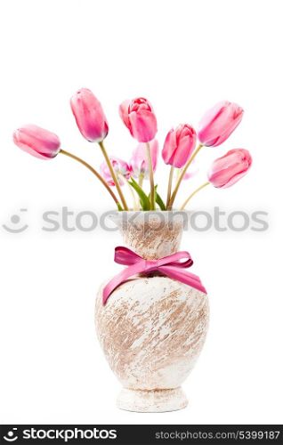 Pink tulips in vase with bow isolated on white