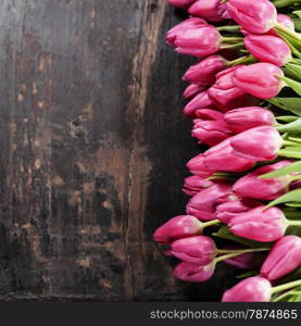 Pink tulips on Old grunge wooden background
