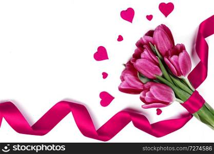 Pink tulips with ribbon and hearts isolated on white background Valentines day concept. Tulips and hearts on white
