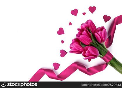 Pink tulips with ribbon and hearts isolated on white background Valentines day concept. Pink tulips with ribbon and hearts