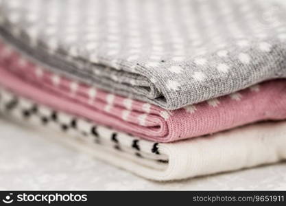 Pink, white and gray pair of child socks on white background
