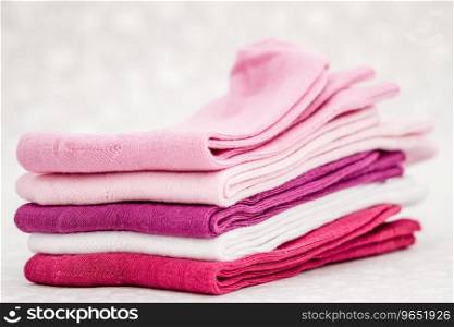 Pink, white and purple pair of child socks on white background