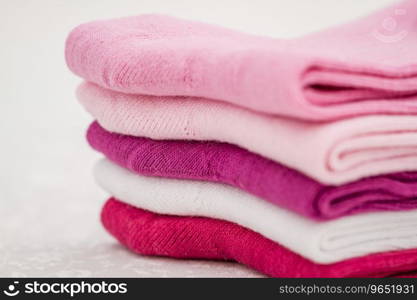 Pink, white and purple pair of child socks on white background