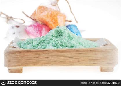 Pink, white, blue, green and orange salt for bath on white background
