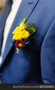 Pinning a Boutonniere for groom on his wedding