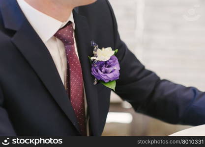 Pinning a Boutonniere for groom on wedding day