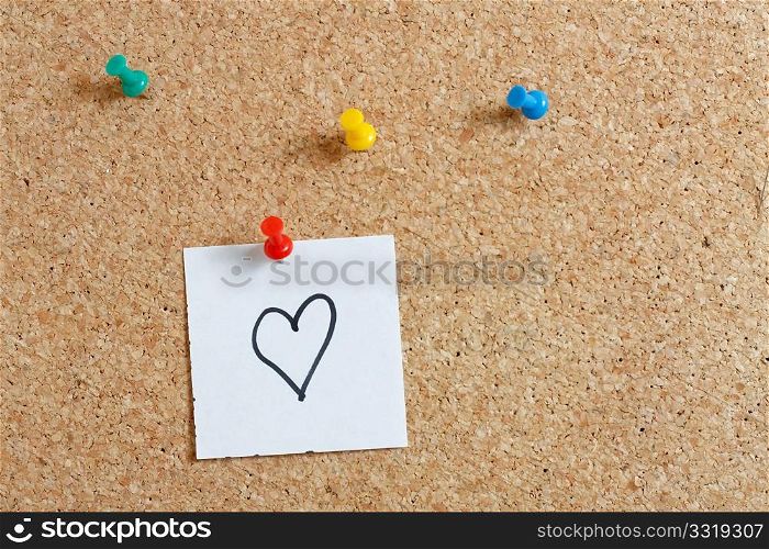 Pins on a wooden notice board