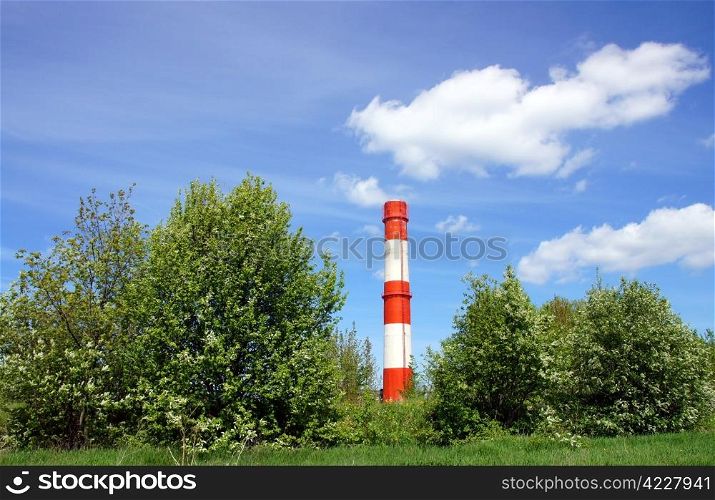 Pipe and the sky on a background of green trees