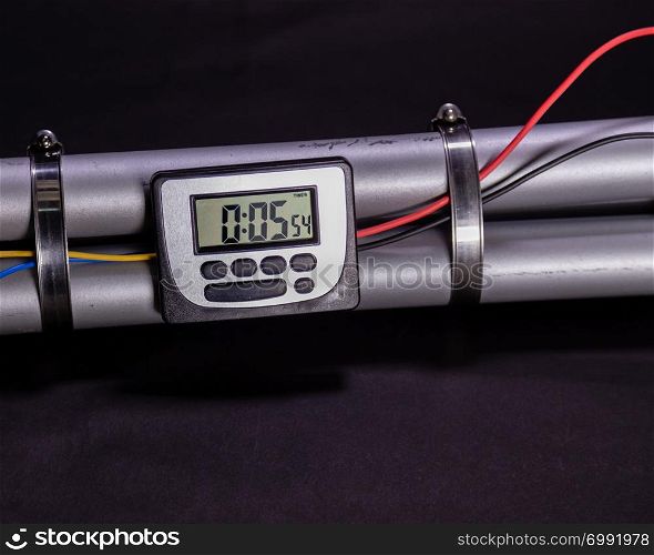 Pipe bomb with an lcd clock timer to trigger detonation on black background